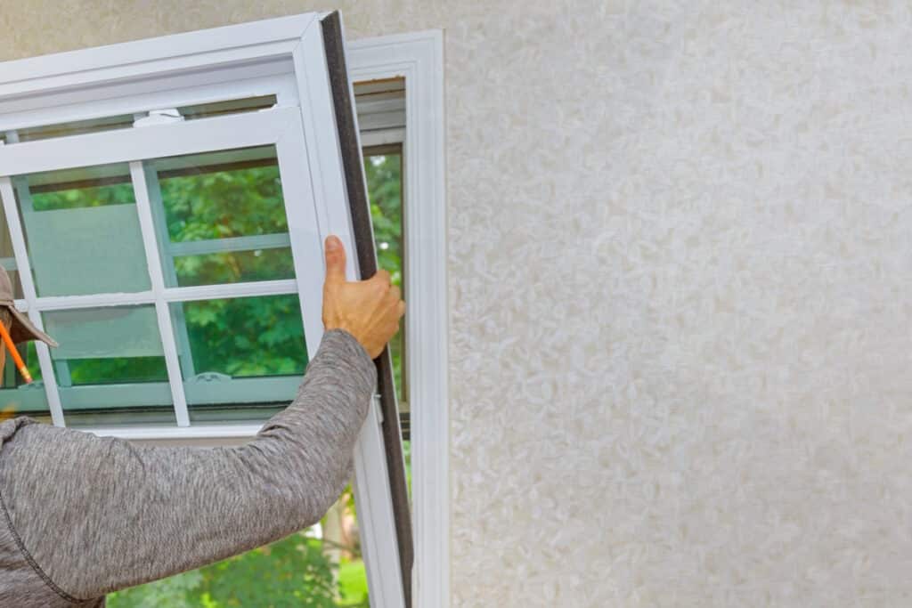vinyl windows installation worker installing new window