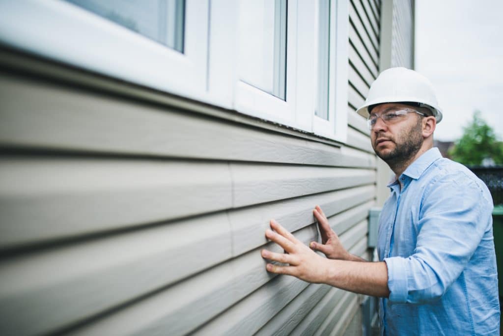 Dallas siding inspecting residential home with siding