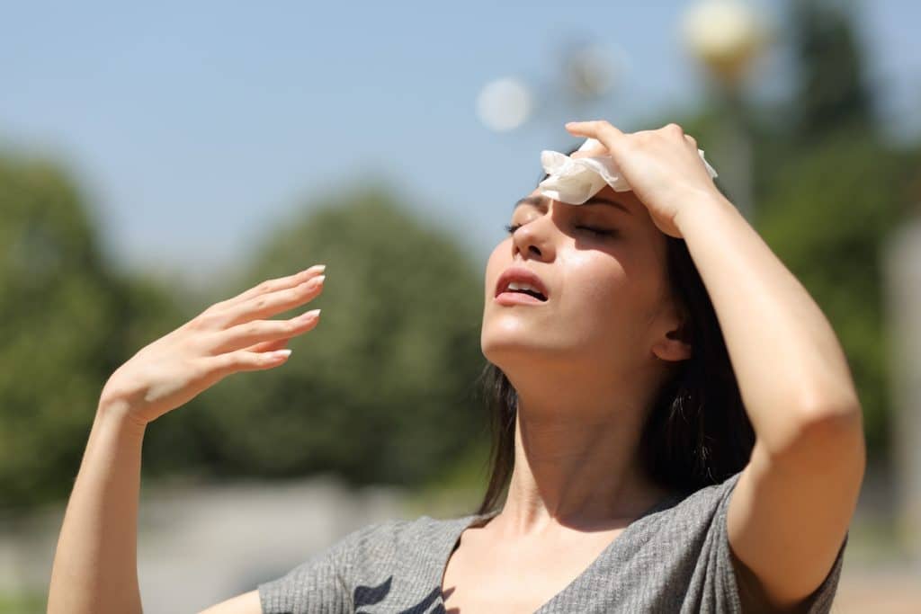Dallas siding survive summer heat - woman drying sweat in a warm summer day