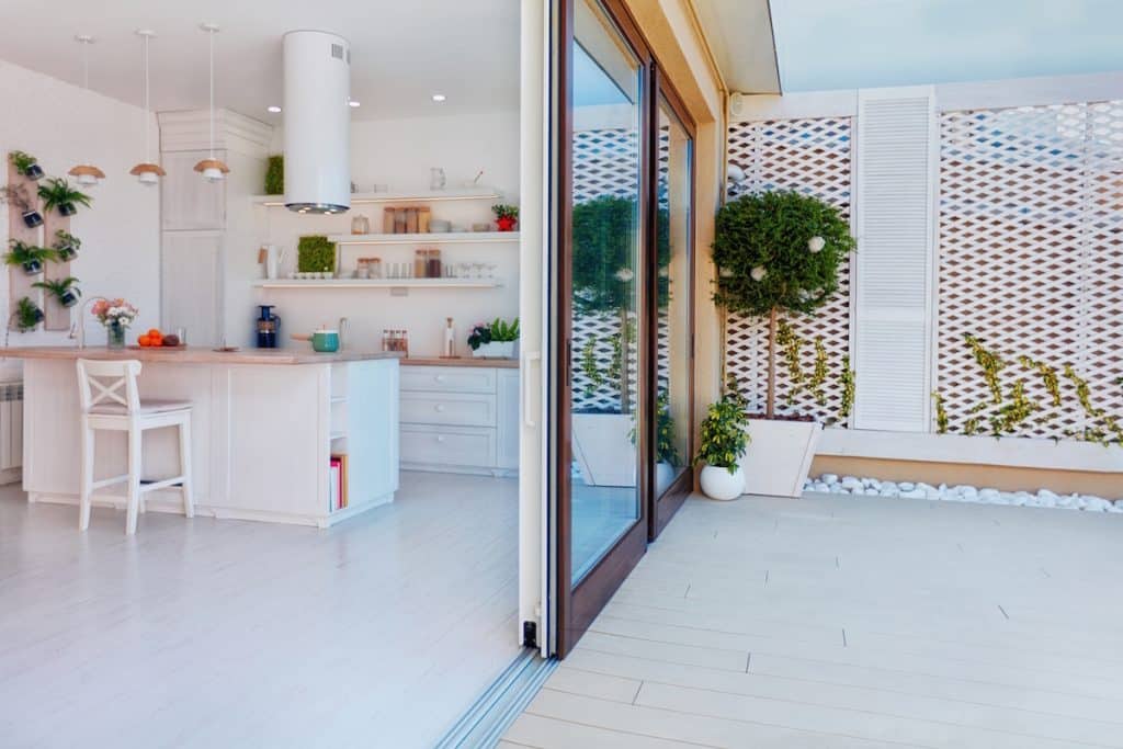 open space kitchen with sliding patio doors and rooftop patio zone